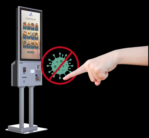 A self-service kiosk with a vertical touchscreen displaying food menu options labeled "CHOOSE RECIPES." A hand pointing towards the screen is shown alongside a green virus symbol crossed out with a red circle, emphasizing a bacteria-free or touchless interaction concept.