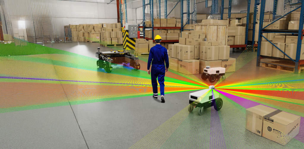 "A warehouse scene with autonomous mobile robots (AMRs) navigating around a worker in a blue uniform and yellow helmet. The robots emit colorful sensor beams for obstacle detection, surrounded by shelves and stacked cardboard boxes."