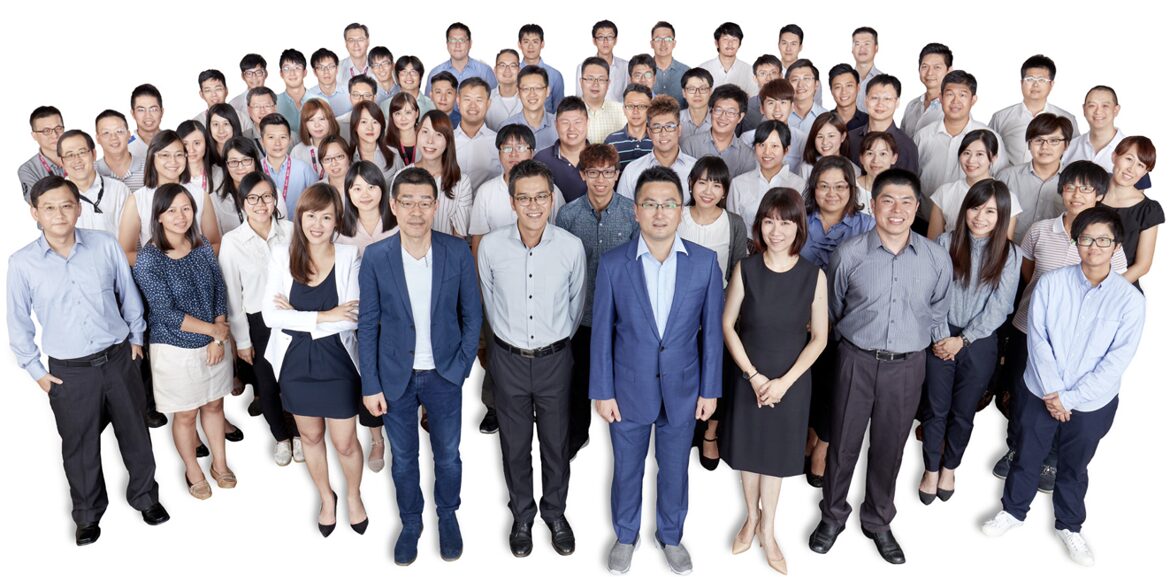 A large group portrait of the LIPS Corporation team, featuring dozens of male and female employees in professional attire, representing the company's collective talent and corporate culture.